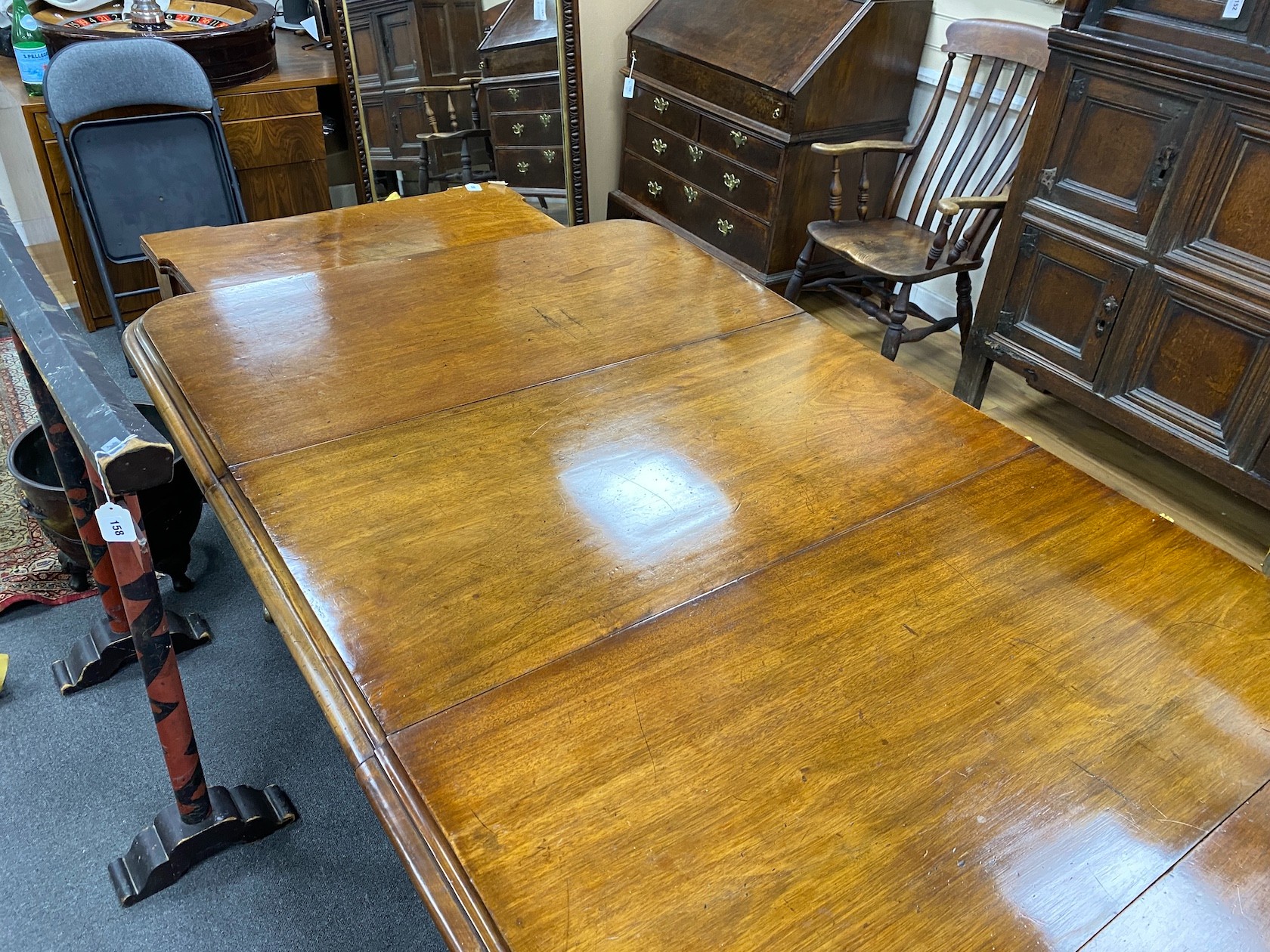 An early Victorian mahogany extending dining table on fluted baluster legs with two leaves, 240cm extended, width 120cm, height 76cm